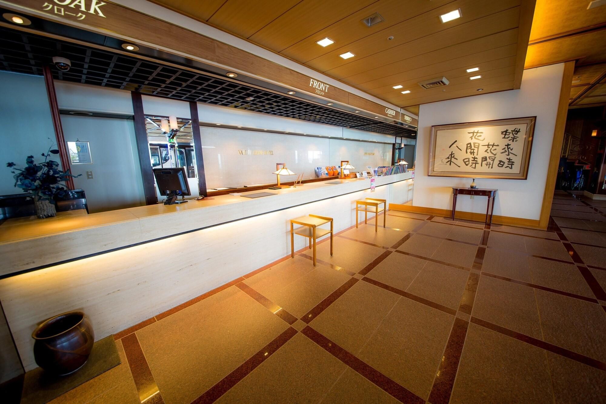 A reception area with a counter, a cash register, and a wall with a framed sign.
