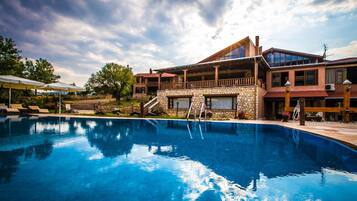 Seasonal outdoor pool, open 9:00 AM to 8:00 PM, pool umbrellas