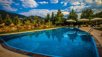 Seasonal outdoor pool, open 9:00 AM to 8:00 PM, pool umbrellas