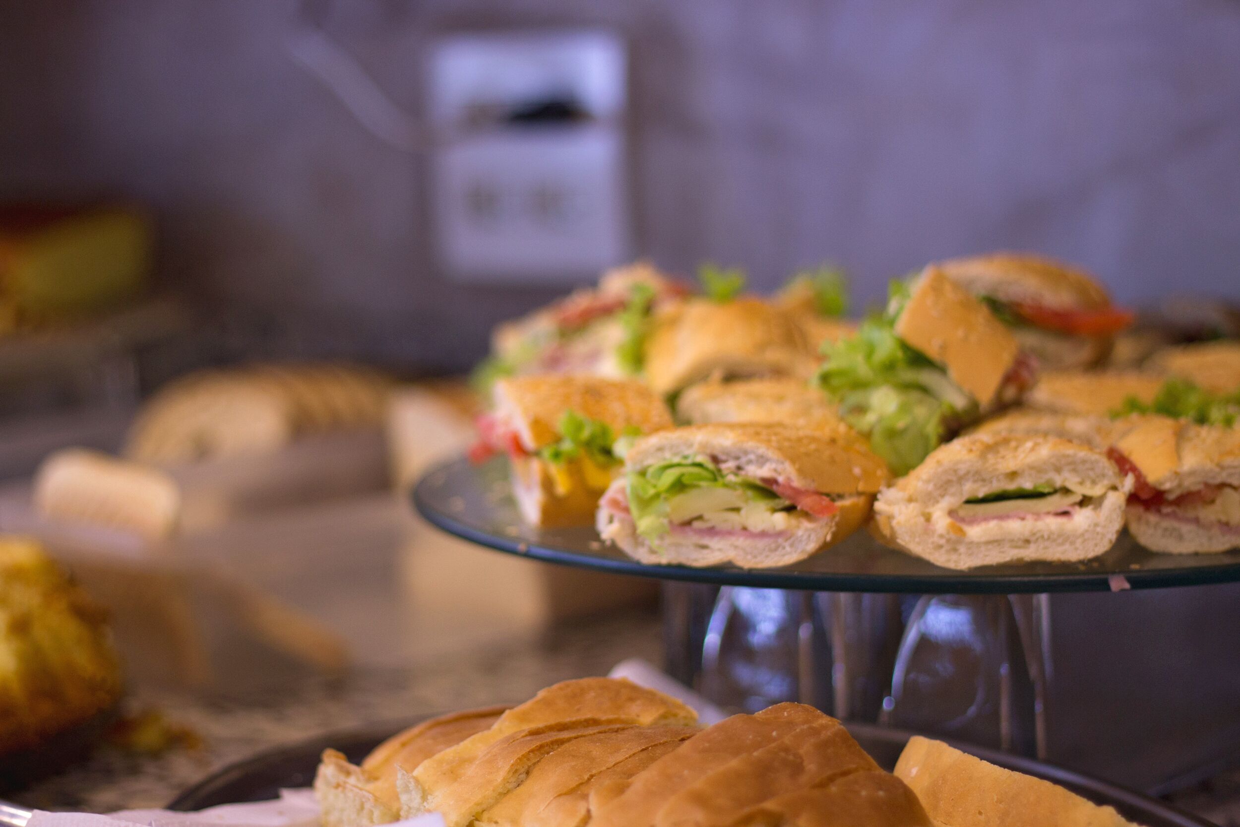 A glass display case with sandwiches.