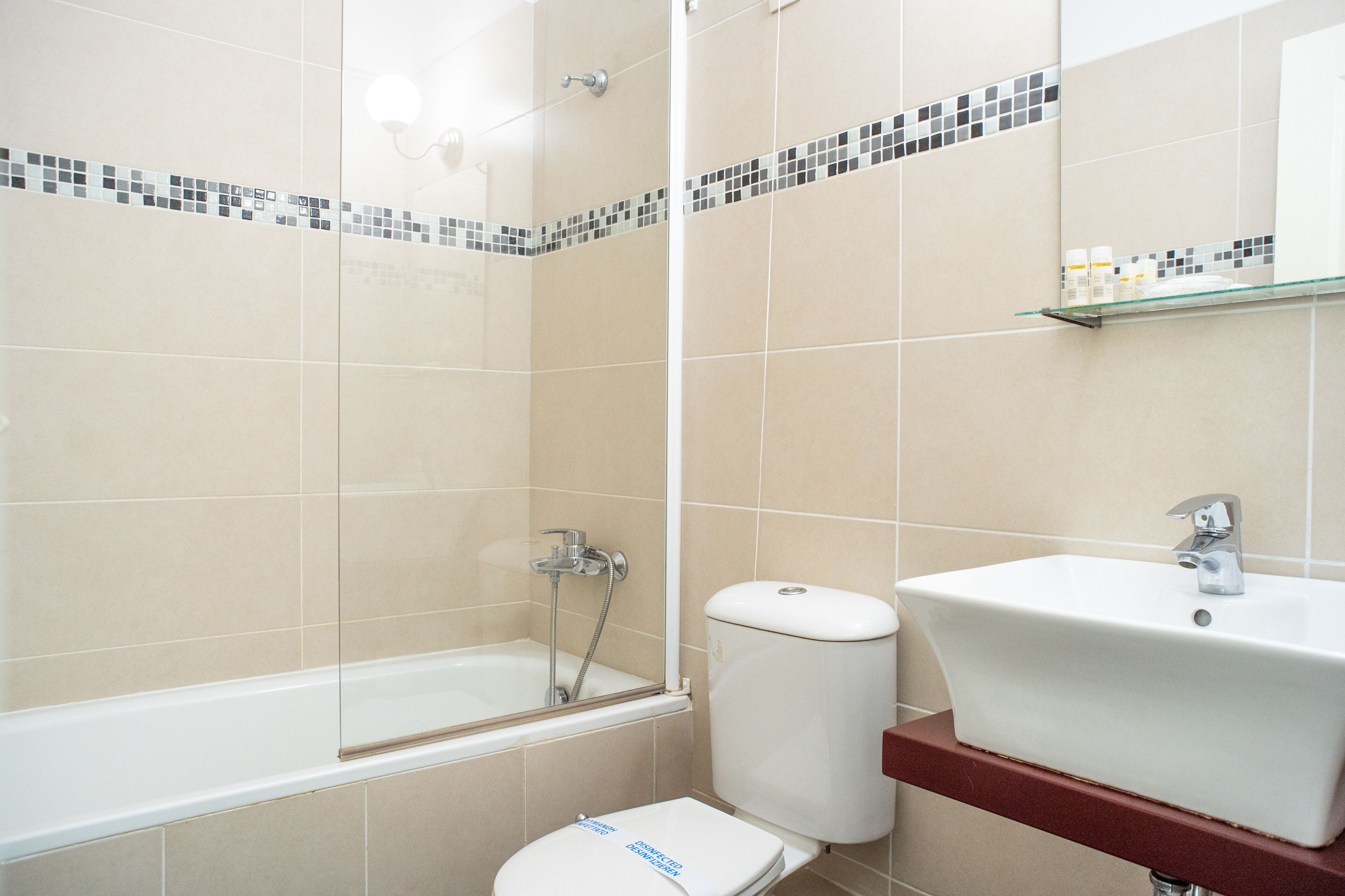 A bathroom with a bathtub, toilet, and sink.