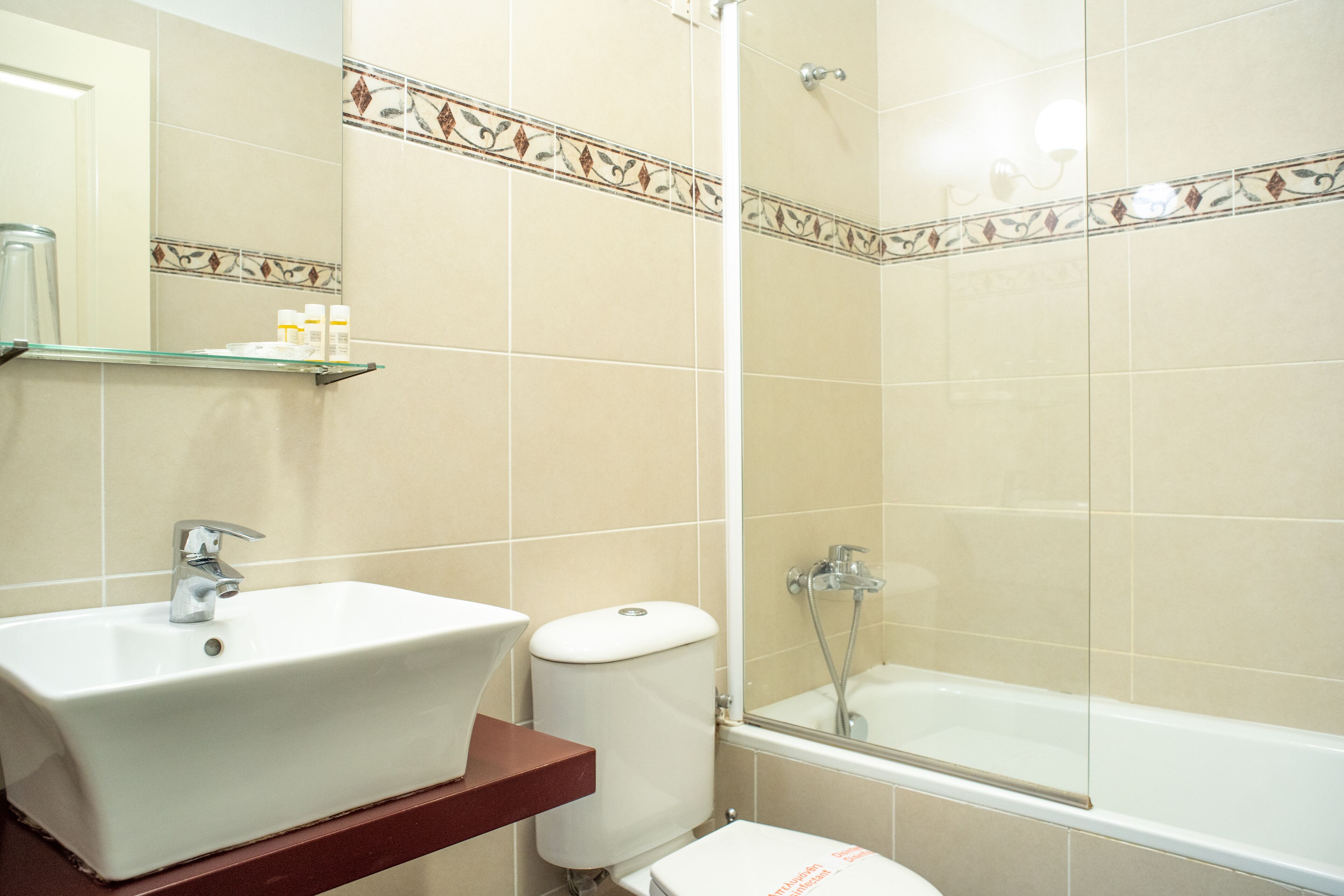 A bathroom with a sink, toilet, and bathtub.