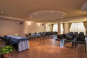 A conference room with a long table, chairs, and a potted plant. - Flagman (Sozopol)