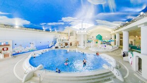 An indoor swimming pool with a ceiling mural, multiple levels, and a central fountain. - Mizunoto (Hakone)