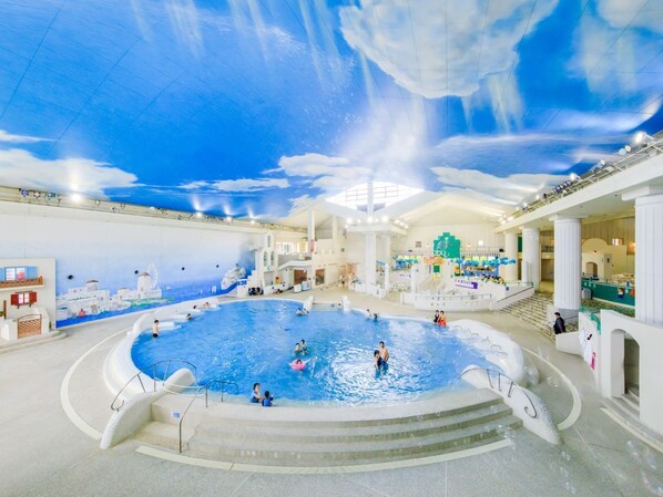 An indoor swimming pool with a ceiling mural, multiple levels, and a central fountain. - Mizunoto (Hakone)