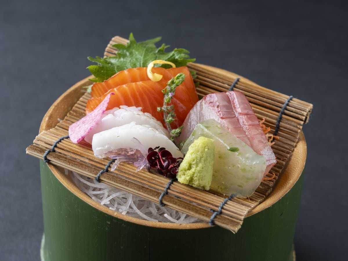 A variety of sushi on a bamboo mat.