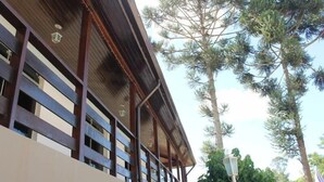 A building with a wooden balcony and a metal roof.