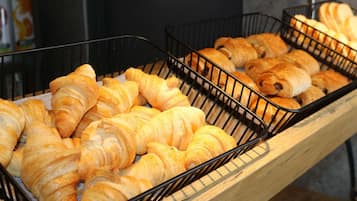 Un espositore con diversi pasticcini in cesti di metallo.
