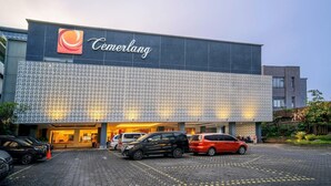 A modern building with a large sign reading 'Cemerlang' and a patterned facade. - Cemerlang (Bandung)