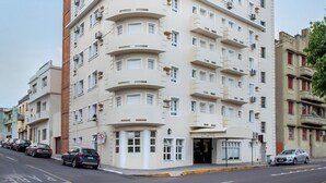 A multi-story building with a curved facade, numbered 1939, featuring multiple balconies and air conditioning units. - Hotel Dom Rafael Executivo (Santa Maria)