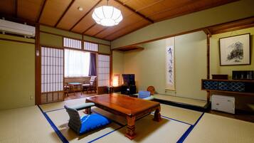 A traditional Japanese room with tatami flooring, a low wooden table, and a shoji screen door.