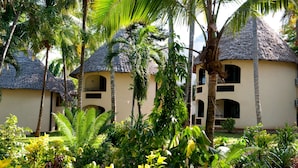 A resort with thatched-roof buildings, surrounded by lush tropical vegetation. - Severin Sea Lodge (Mombasa)