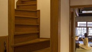 A wooden staircase leading to an upper floor. - Sheena and Ippei - Hostel (Tokyo)