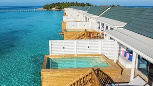 An overwater bungalows with wooden walkways and clear blue water. - OBLU NATURE Helengeli - All-Inclusive with Free Transfers (Helengeli)