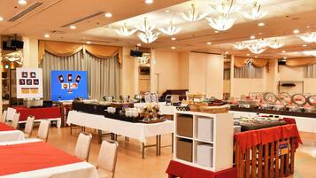 A buffet setup with tables and chairs, a display board with food items, and a ceiling with multiple light fixtures.