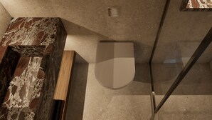 Une salle de bain moderne avec un meuble-lavabo en marbre, des toilettes et une cabine de douche en verre.