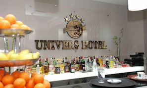 A bar area with a variety of liquor bottles and a fruit display. - Univers (Elbasan)