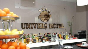 A bar area with a variety of liquor bottles and a fruit display. - Univers (Elbasan)