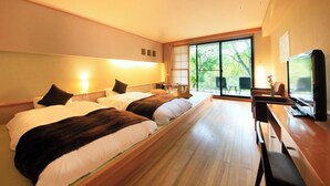 A hotel room with two beds, a TV, a desk, and a balcony with a view of trees. - Okunikko Hotel Shikisai (Nikko)