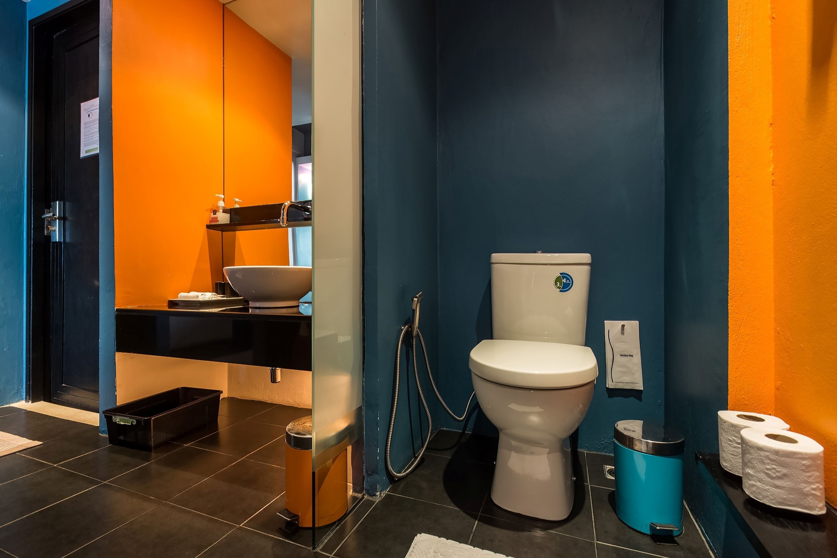 A bathroom with a toilet, sink, and shower.