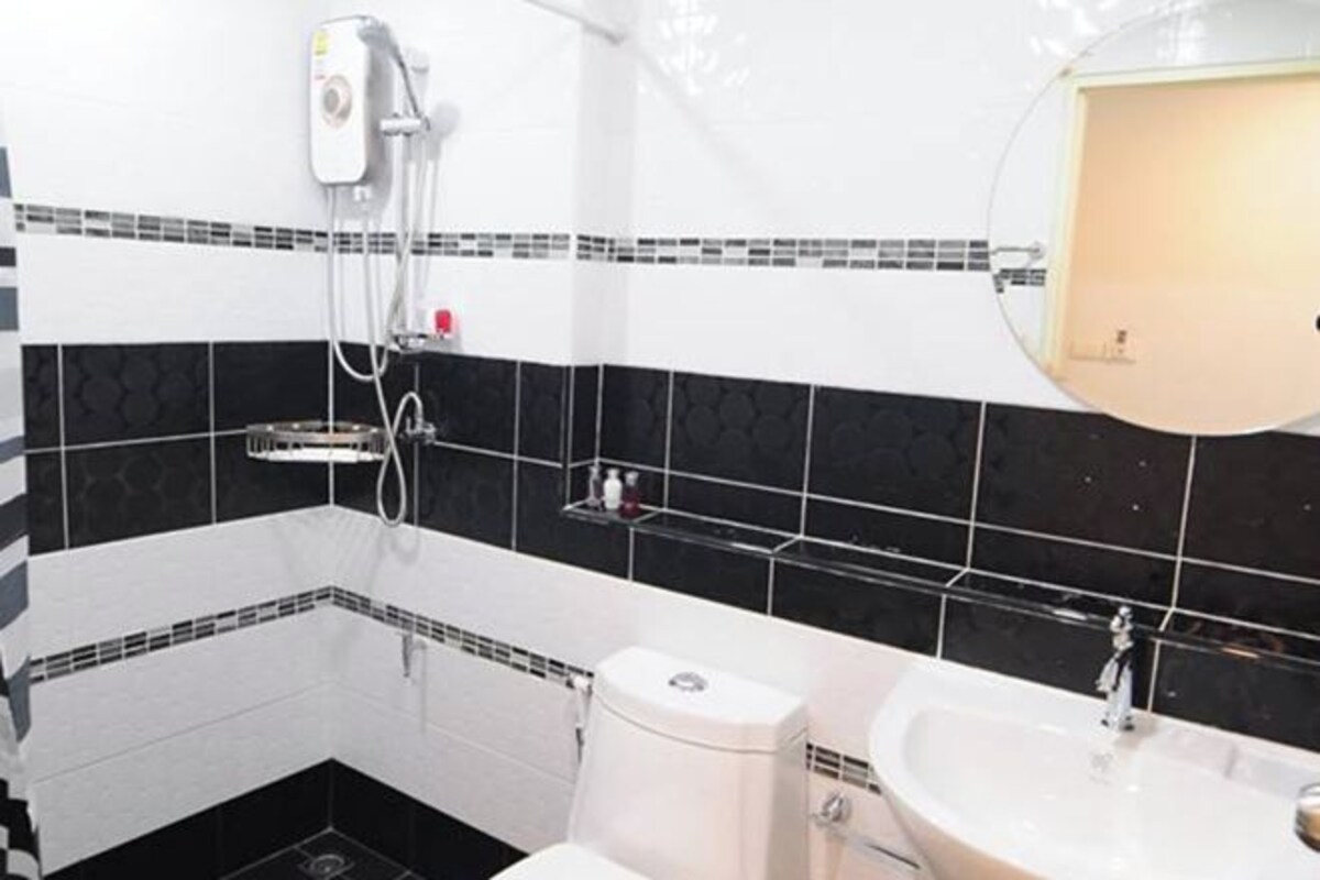 A bathroom with a toilet, sink, and shower.