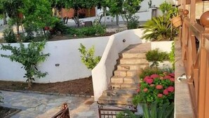 A stone staircase leading to a white building with a wooden railing. - Seralis (South Pelion)
