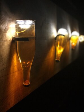 A row of glasses on a wooden surface, likely in a bar or restaurant setting. - Le Clos des Terres Soudées (Vrigny)