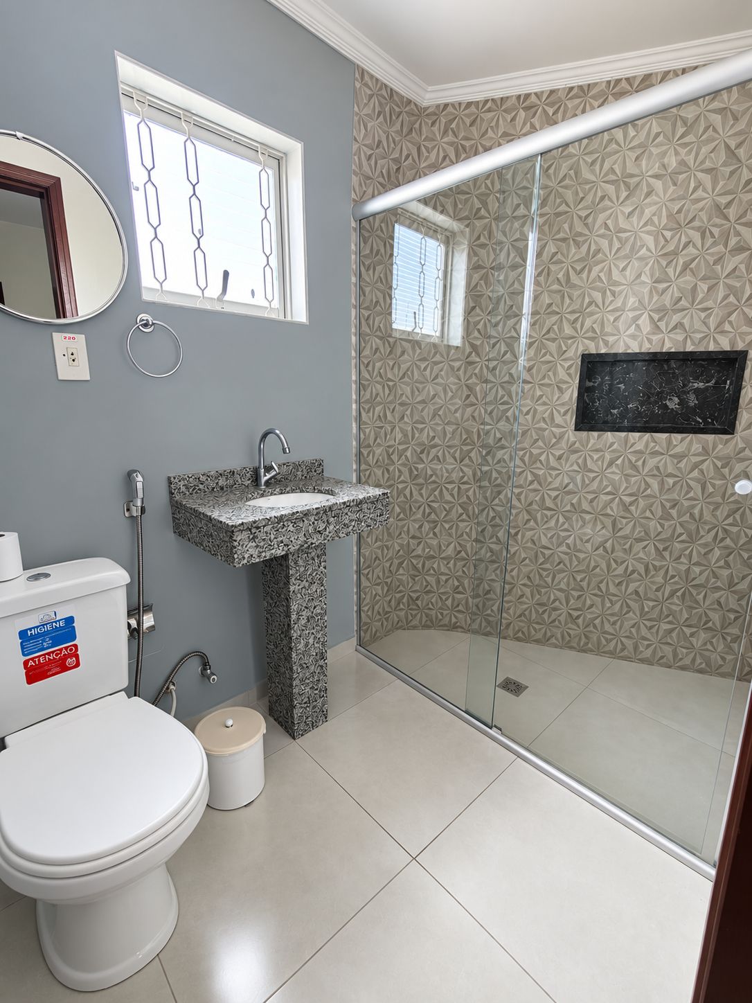 A bathroom with a toilet, sink, and shower.