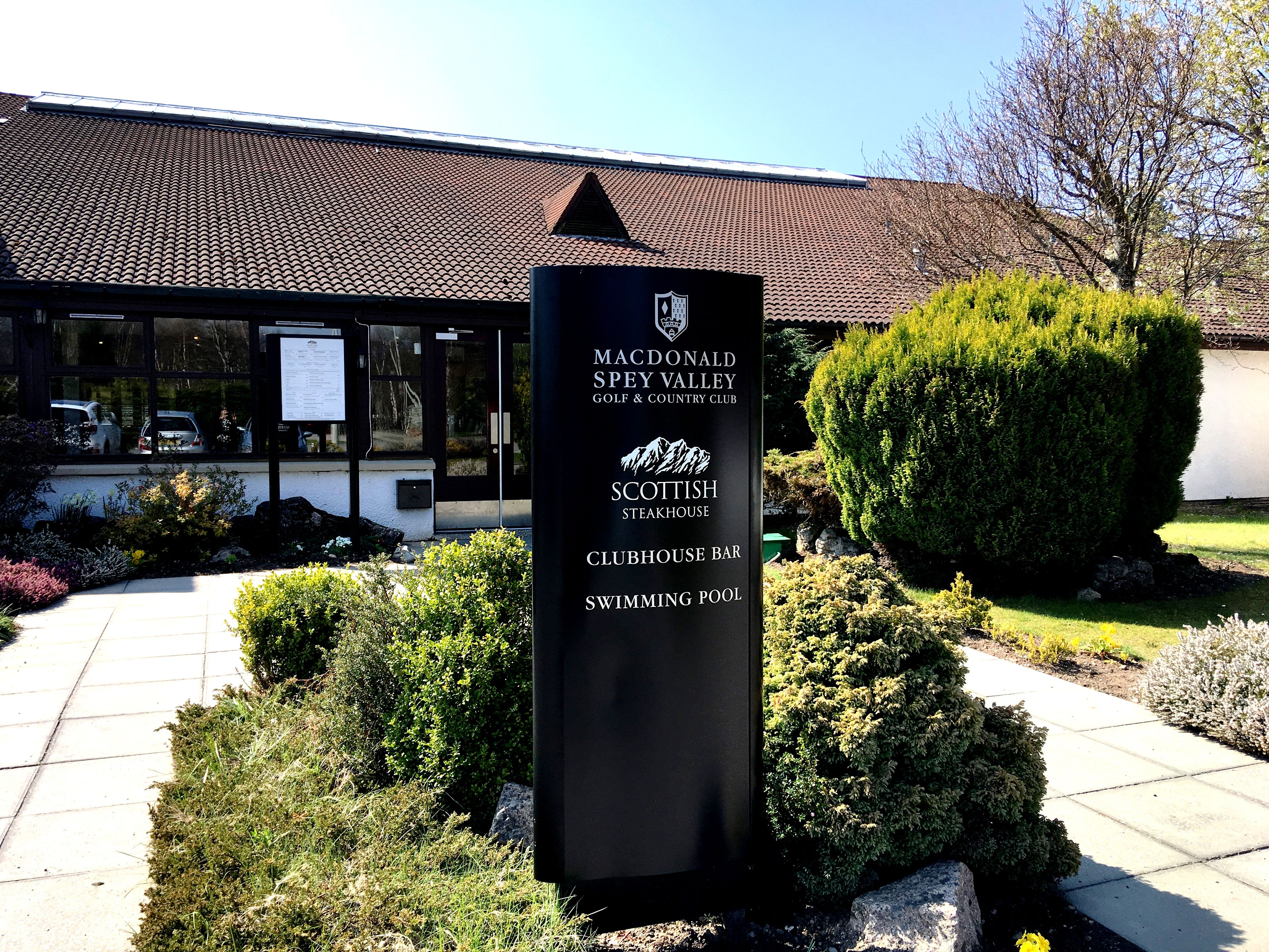 A signboard for McDonald’s Spey Valley Golf & Country Club, listing amenities like Scottish Steakhouse, Clubhouse Bar, and Swimming Pool.