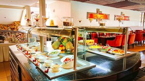 A buffet area with various food items and a glass display case.