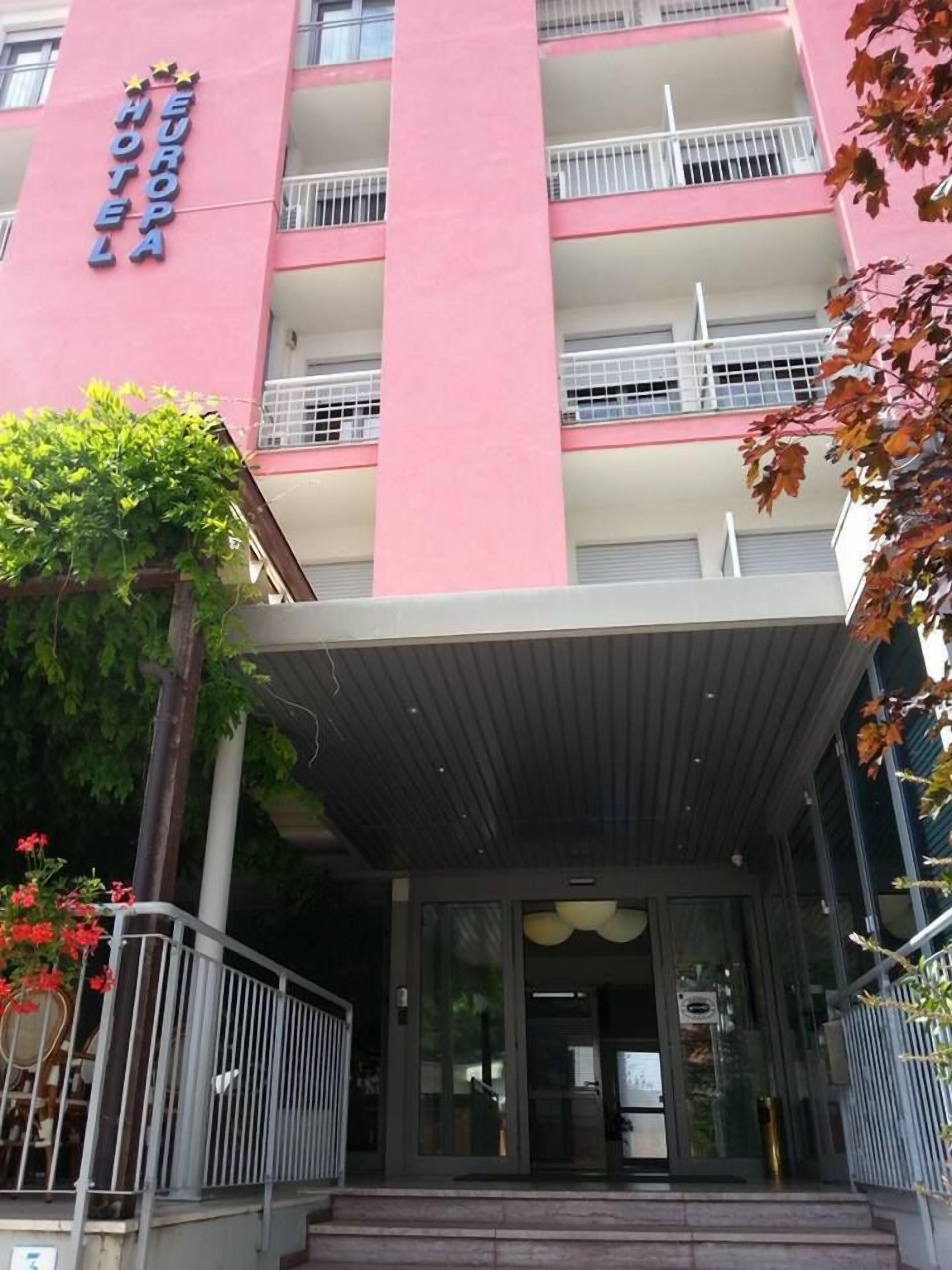 A pink building with a sign reading "EUROPA HOTEL".