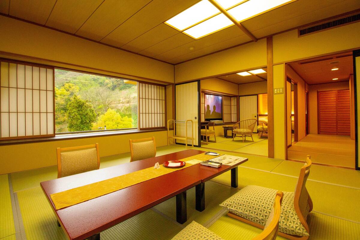 A traditional Japanese room with tatami flooring, a low table, and shoji screens.