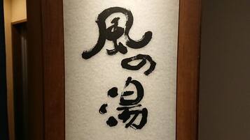 A vertical calligraphy sign on a wall.