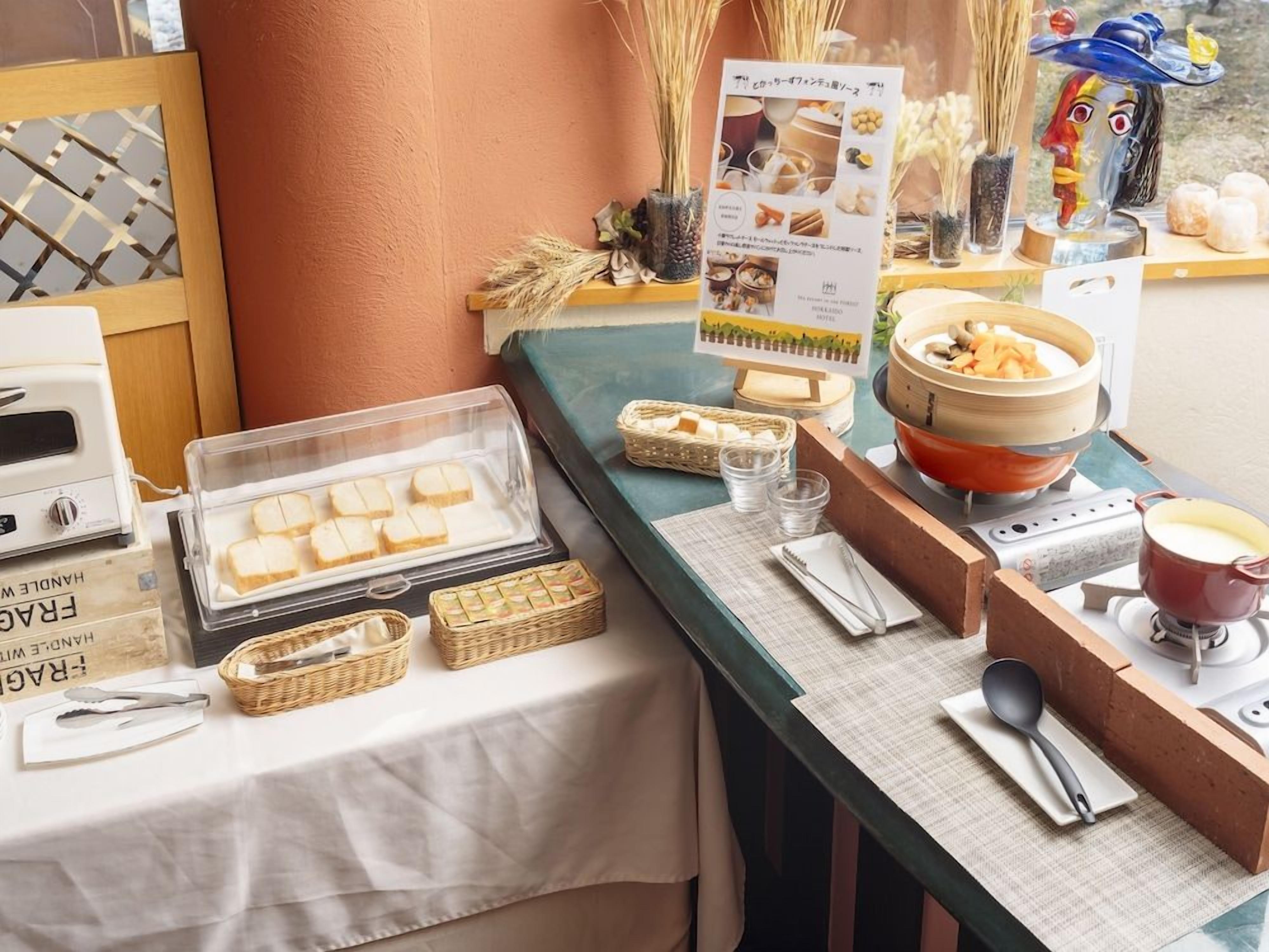 A buffet setup with various food items and a menu sign.