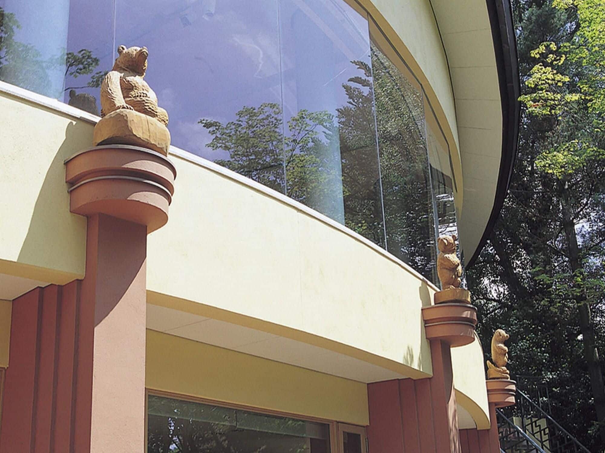 A building with a curved facade and a series of stone statues on the exterior.