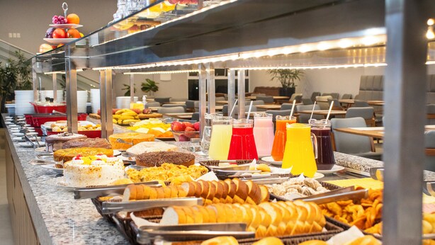 A buffet with various food items and beverages.