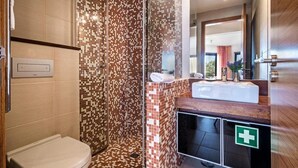 Une salle de bain moderne équipée d’une douche, de toilettes et d’un lavabo.