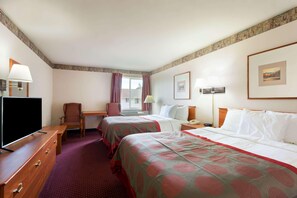 A hotel room with two beds, a desk, a chair, a television, and a window with curtains. - Ramada by Wyndham Seatac Airport North (Tukwila)