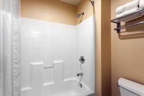 Une salle de bain avec douche, toilettes et porte-serviettes.