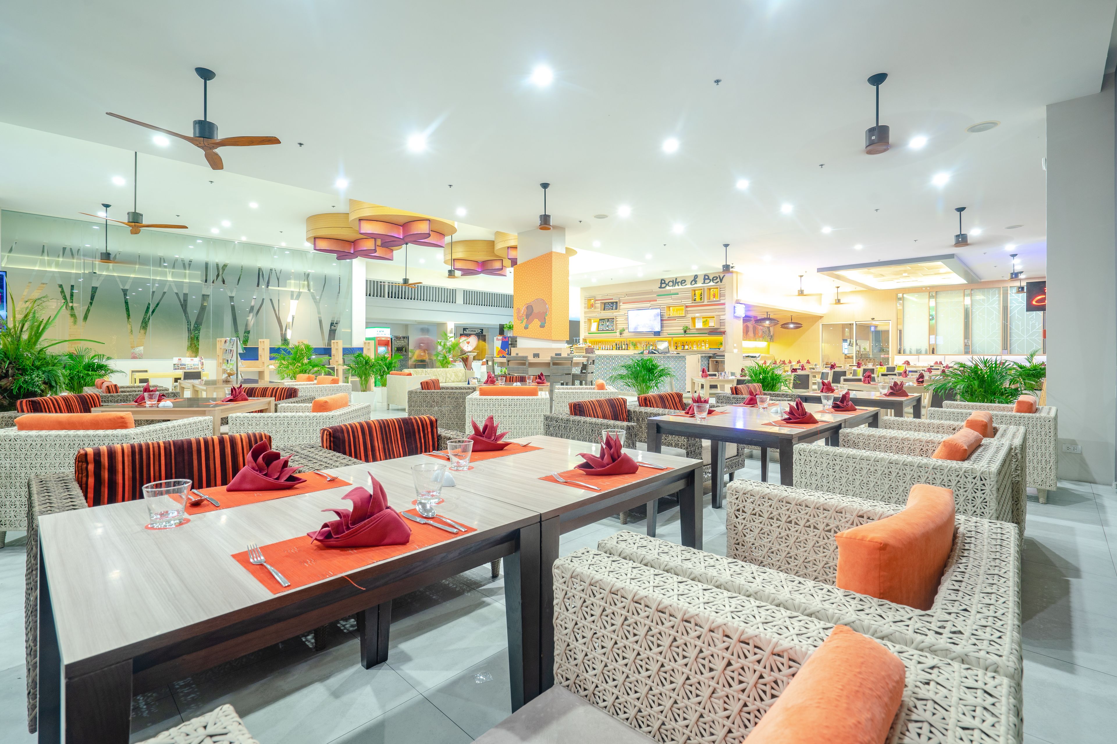 A spacious restaurant with high ceilings, modern lighting, and comfortable seating areas.
