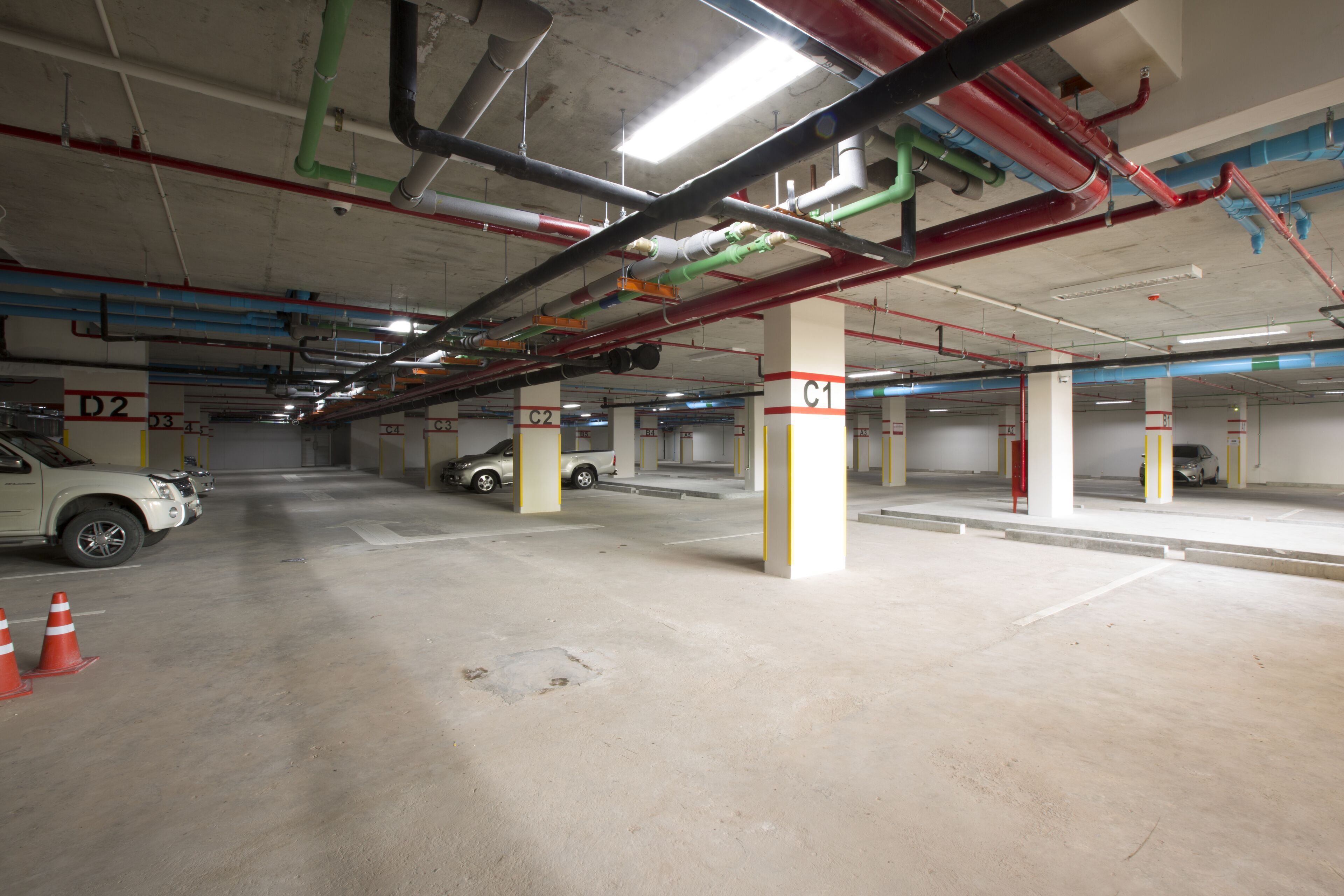 An underground parking garage with multiple levels, concrete floors, and visible structural columns.