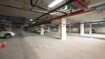 An underground parking garage with multiple levels, concrete floors, and visible structural columns.