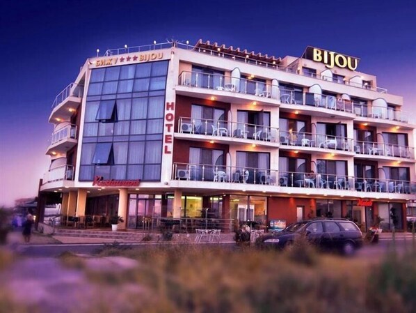 A multi-story hotel with balconies, a sign reading 'BIJOU,' and a visible entrance. - Bijou (Ravda)