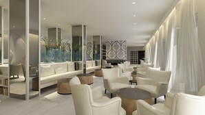 A modern lounge area with white furniture, a patterned wall, and a large window with sheer curtains. - Bellevue Maradiso Casa by Aminess (Orebic)
