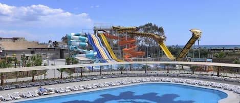 A water park with multiple slides and a pool with a gear design.
