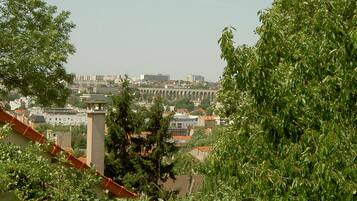 A view of a cityscape with buildings and a bridge in the background.