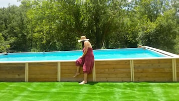 Relax by the pool surrounded by lush greenery.