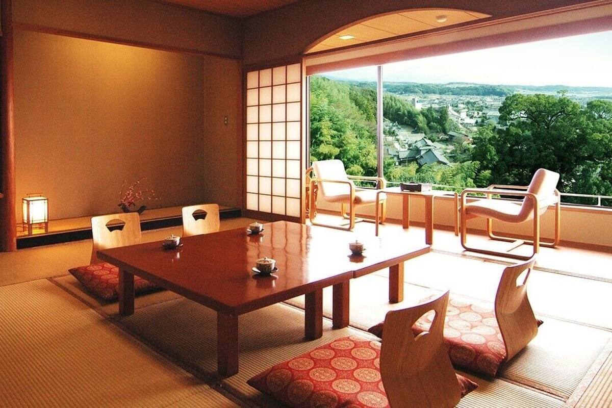A traditional Japanese room with tatami flooring, a low wooden table, and sliding doors.