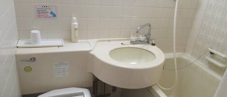 A bathroom with a toilet, sink, and bathtub.