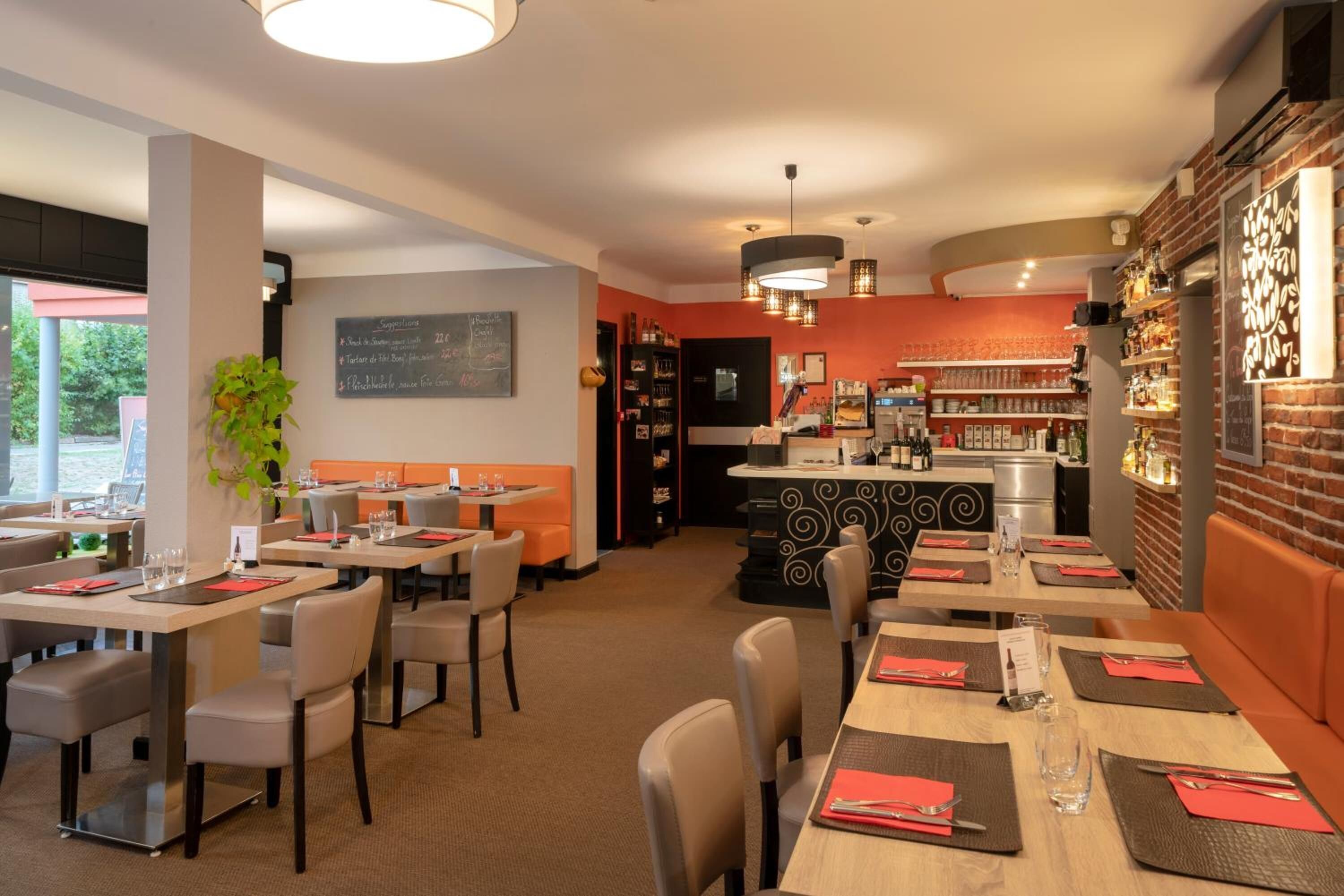 A restaurant with multiple dining tables, chairs, and a bar area.